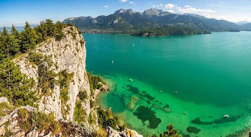 Vue plongeante sur l'eau vert émeraude depuis les falaises du Roc de Chère